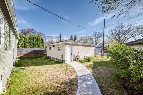 Detached garage with stucco exterior and a concrete pathway - 11303 60 Street, Edmonton, AB - Outdoor