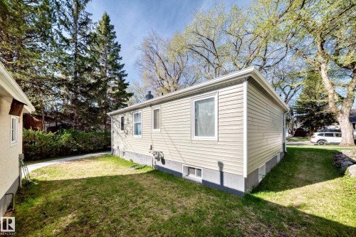 Beige horizontal siding exterior with a white window frame - 11303 60 Street, Edmonton, AB - Outdoor