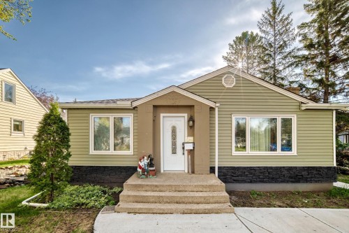 Ranch-style exterior with olive green siding and dark stone veneer accents - 11303 60 Street, Edmonton, AB - Outdoor