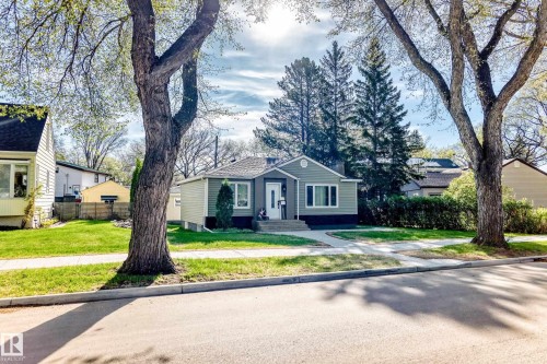 Charming bungalow featuring light green siding, white trim, and a dark foundation - 11303 60 Street, Edmonton, AB - Outdoor