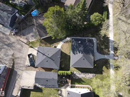 Property featuring two distinct buildings with dark shingled roofs - 11303 60 Street, Edmonton, AB 