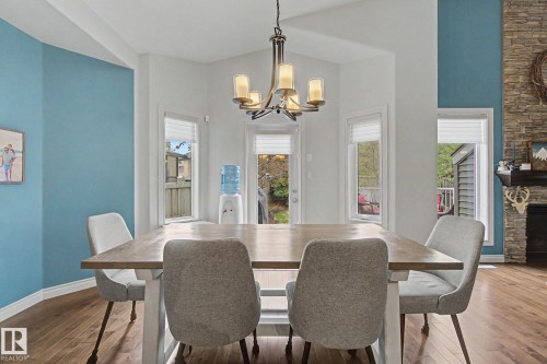 3433 West Landing Landing, Edmonton, AB - Indoor Photo Showing Dining Room With Fireplace