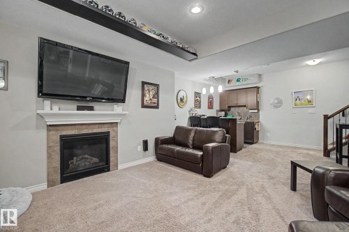 3433 West Landing Landing, Edmonton, AB - Indoor Photo Showing Living Room With Fireplace