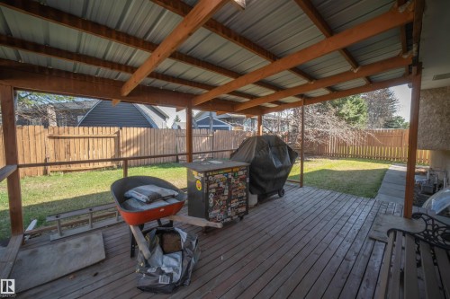 Covered outdoor deck with wood-finish flooring, a metal roof, and exposed wood beams - 4724 38B Avenue Nw, Edmonton, AB - Outdoor With Deck Patio Veranda With Exterior