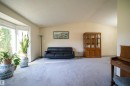 Spacious living area featuring a large bay window, vaulted ceilings, and light-toned carpeting - 4724 38B Avenue Nw, Edmonton, AB  - Indoor Photo Showing Living Room 