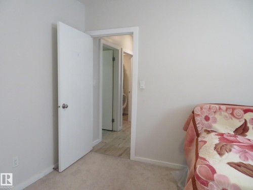 Light gray wall finishes with white trim and a white interior door - 11840B 122 Street, Edmonton, AB - Indoor Photo Showing Bedroom
