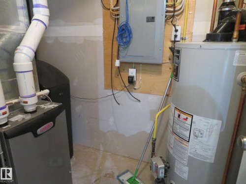 Utility area featuring a water heater, furnace, and electrical panel - 11840B 122 Street, Edmonton, AB - Indoor Photo Showing Basement