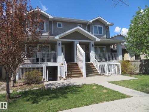 Contemporary duplex exterior featuring gray siding and white trim - 11840B 122 Street, Edmonton, AB - Outdoor With Deck Patio Veranda With Facade