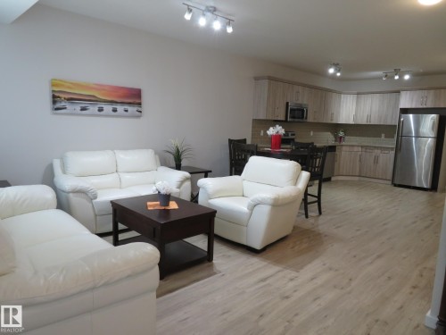 Open-concept living area featuring wood-finish flooring, recessed lighting, and track lighting - 11840B 122 Street, Edmonton, AB - Indoor Photo Showing Living Room