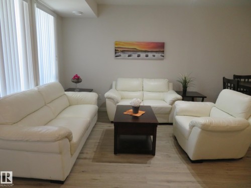 Open-concept living space featuring light wood-finish flooring and neutral wall tones - 11840B 122 Street, Edmonton, AB - Indoor Photo Showing Living Room