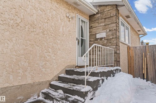 Exterior featuring textured stucco siding and a stone facade - 115 Warwick Road, Edmonton, AB - Outdoor