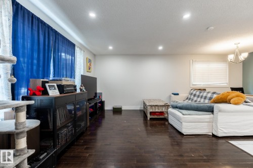 Dark wood-finish flooring extending throughout the space - 3004 68 Street, Edmonton, AB - Indoor