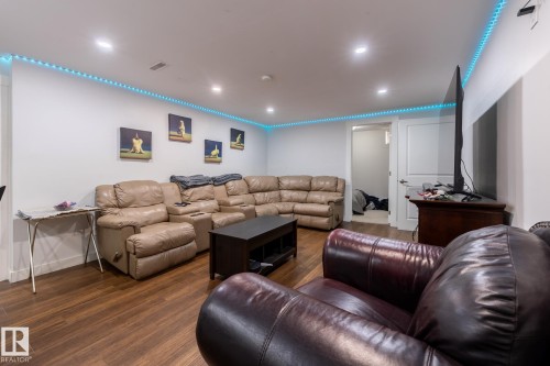 Spacious room featuring wood-finish flooring, white walls, and recessed ceiling lighting - 3004 68 Street, Edmonton, AB - Indoor