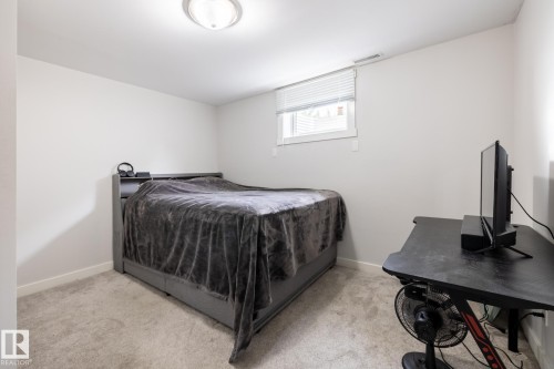 Carpeted room featuring white walls, a recessed window with blinds, and a flush-mount ceiling light fixture - 3004 68 Street, Edmonton, AB - Indoor Photo Showing Bedroom