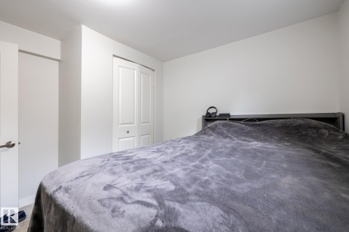Bedroom featuring a bi-fold door closet and neutral wall finishes - 3004 68 Street, Edmonton, AB - Indoor Photo Showing Bedroom