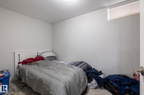 White painted walls with a window featuring horizontal blinds - 3004 68 Street, Edmonton, AB - Indoor Photo Showing Bedroom