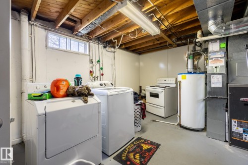 Utility space featuring a washer, dryer, water heater, and furnace - 3004 68 Street, Edmonton, AB - Indoor Photo Showing Laundry Room