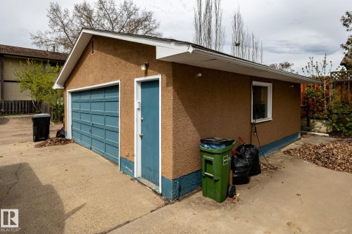Detached garage structure featuring stucco siding and a concrete driveway - 3004 68 Street, Edmonton, AB - Outdoor With Exterior