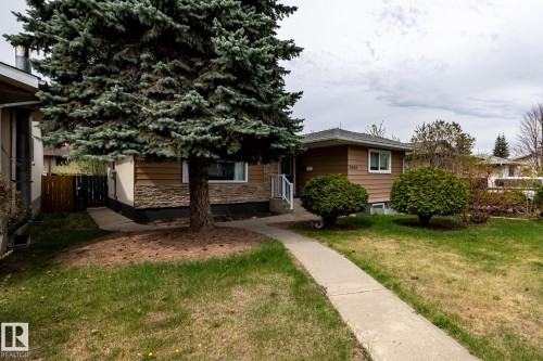 Exterior featuring brown horizontal siding and a stone facade accent - 3004 68 Street, Edmonton, AB - Outdoor