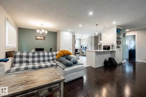 Open-concept living space with dark wood-finish flooring - 3004 68 Street, Edmonton, AB - Indoor Photo Showing Living Room