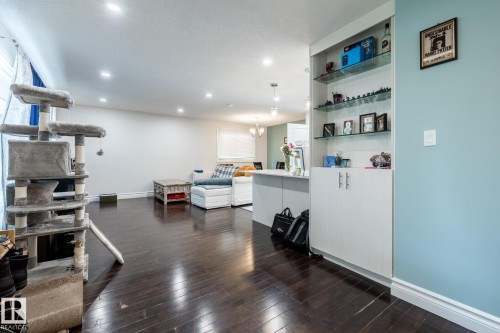 Rich wood-finish flooring extending throughout the space - 3004 68 Street, Edmonton, AB - Indoor