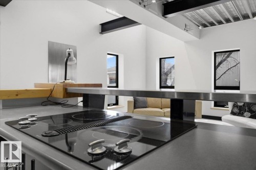Integrated cooktop with downdraft ventilation, set within a gray countertop - 8709 92A Avenue, Edmonton, AB - Indoor Photo Showing Kitchen