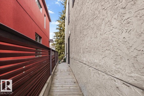 Wood-finish walkway featuring a slatted privacy fence - 8709 92A Avenue, Edmonton, AB - Outdoor