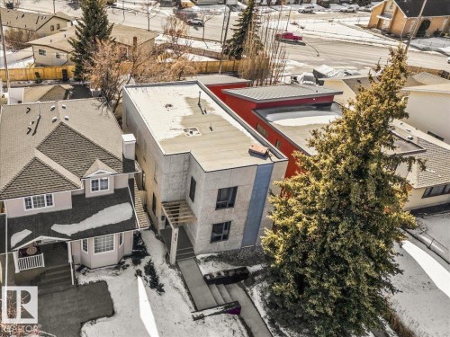 Modern multi-story property with flat roofing and a red-accented upper level - 8709 92A Avenue, Edmonton, AB - Outdoor