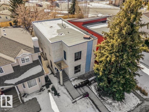 Modern multi-story building featuring a flat roof and a vertical blue architectural accent - 8709 92A Avenue, Edmonton, AB - Outdoor