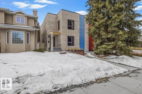 Modern architectural facade featuring vertical blue and red accent panels - 8709 92A Avenue, Edmonton, AB - Outdoor With Facade