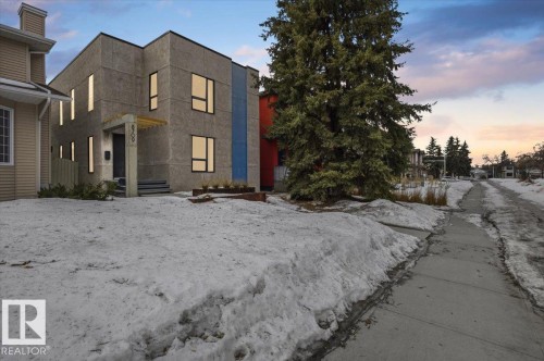 Modern architectural exterior featuring a textured facade and contrasting blue paneling - 8709 92A Avenue, Edmonton, AB - Outdoor