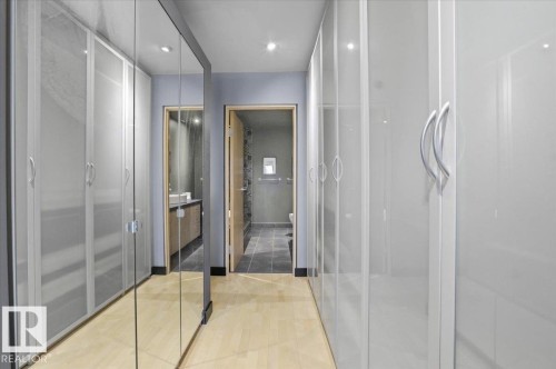 Hallway featuring light wood-finish flooring, recessed lighting, and a full-length mirrored panel - 8709 92A Avenue, Edmonton, AB - Indoor Photo Showing Bathroom