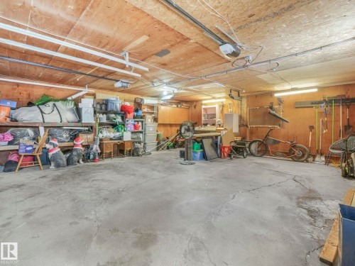 The garage features dual space heaters, EV/RV roughed in, and workshop space! - 5406 46 Avenue, Wetaskiwin, AB - Indoor Photo Showing Garage
