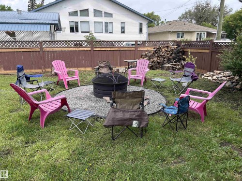Summer photo of the fire pit area - 5406 46 Avenue, Wetaskiwin, AB - Outdoor With Deck Patio Veranda