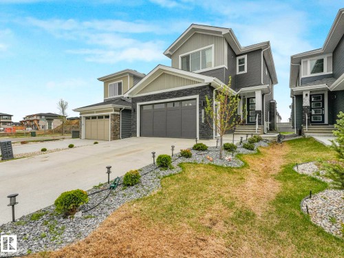 Contemporary two-story residence featuring a dark gray and light gray exterior with stone accents - 16307 19 Avenue, Edmonton, AB - Outdoor With Facade