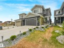 Contemporary two-story residence featuring a dark gray and light gray exterior with stone accents - 16307 19 Avenue, Edmonton, AB  - Outdoor With Facade 