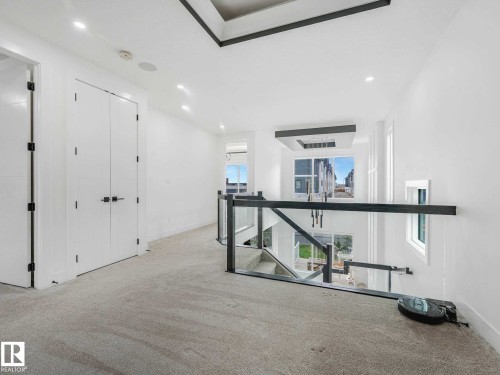Upper-level hallway featuring light carpeting, recessed lighting, and white walls - 16307 19 Avenue, Edmonton, AB - Indoor Photo Showing Other Room