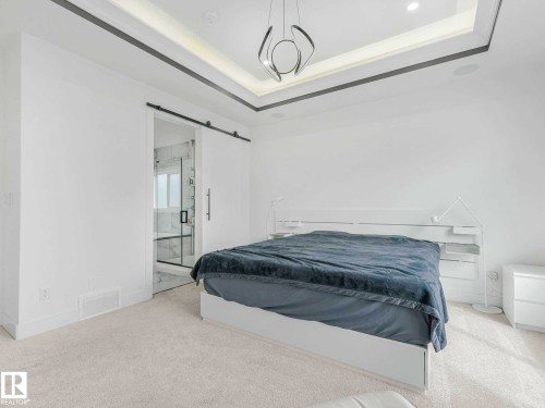 Bedroom featuring soft carpet flooring and a tray ceiling with recessed lighting - 16307 19 Avenue, Edmonton, AB - Indoor Photo Showing Bedroom