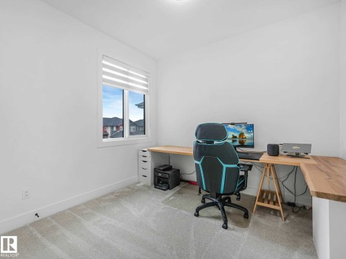 Bright room featuring a window with integrated blinds, light-toned carpet flooring, white painted walls, and a recessed ceiling light fixture - 16307 19 Avenue, Edmonton, AB - Indoor Photo Showing Office