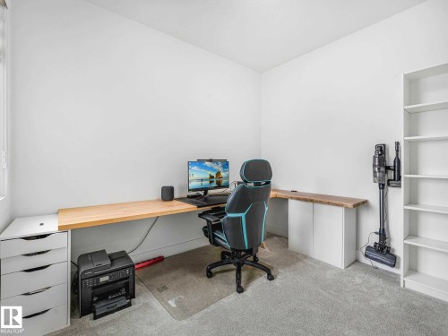 Well-lit interior space featuring light-toned walls and neutral carpeting - 16307 19 Avenue, Edmonton, AB - Indoor Photo Showing Office