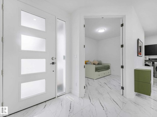 Entryway featuring a white door with three frosted glass panels, a full-length frosted glass sidelight, and marble-look tile flooring - 16307 19 Avenue, Edmonton, AB - Indoor Photo Showing Other Room