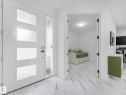Entryway featuring a white door with three frosted glass panels, a full-length frosted glass sidelight, and marble-look tile flooring - 16307 19 Avenue, Edmonton, AB  - Indoor Photo Showing Other Room 