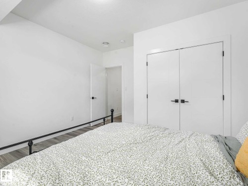 Bright room featuring white walls, wood-finish flooring, and recessed ceiling lighting - 16307 19 Avenue, Edmonton, AB - Indoor Photo Showing Bedroom