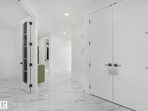 White porcelain tile flooring with subtle grey veining - 16307 19 Avenue, Edmonton, AB - Indoor Photo Showing Other Room