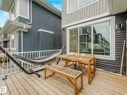 Spacious outdoor deck with wood-finish flooring and white perimeter railing - 16307 19 Avenue, Edmonton, AB - Outdoor With Deck Patio Veranda With Exterior