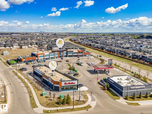 Commercial plaza with a gas station, a drive-through coffee shop, and a multi-unit retail building - 16307 19 Avenue, Edmonton, AB - Outdoor With View