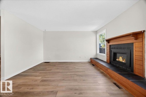 Wood-finish flooring throughout - 32 1820 56 Street, Edmonton, AB - Indoor With Fireplace