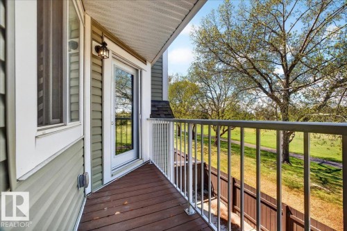 Private balcony featuring wood-finish decking and a white metal railing - 32 1820 56 Street, Edmonton, AB - Outdoor With Balcony With Exterior