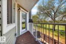 Private balcony featuring wood-finish decking and a white metal railing - 32 1820 56 Street, Edmonton, AB  - Outdoor With Balcony With Exterior 