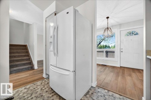 Transitional flooring featuring hexagonal tile and wood-finish planks - 32 1820 56 Street, Edmonton, AB - Indoor Photo Showing Other Room